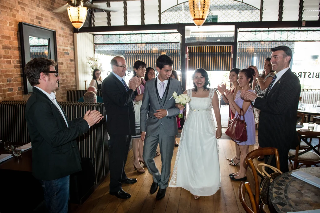 The couple stand with their wedding party during the ceremony.